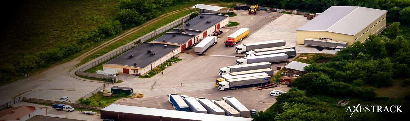 Aerial view of a plant yard with multiple trucks and trailers, showing organized vehicle movement and yard management operations